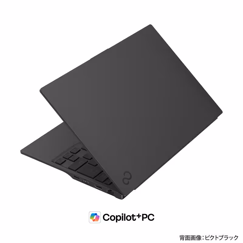 Ordinateur portable Fujitsu FMV WU6-L1 fermé avec logo Copilot+ en arrière-plan noir