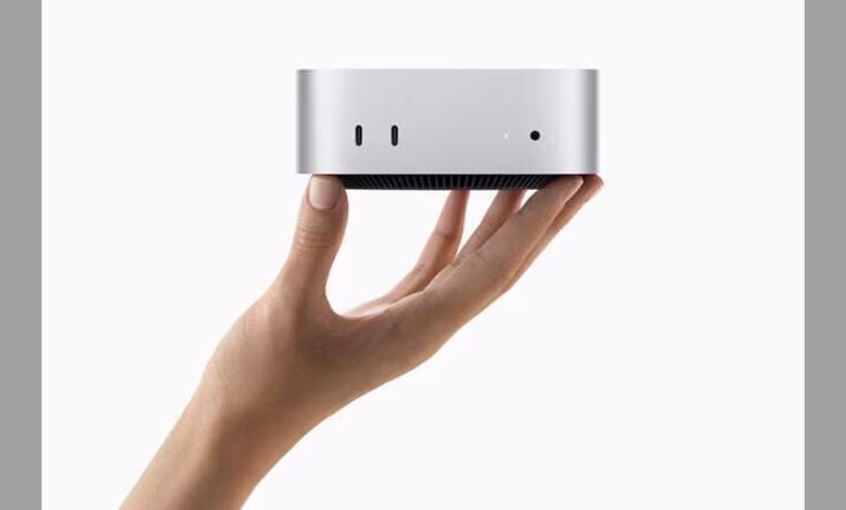 Apple Houston : Mac mini assemblé aux États-Unis et montée en puissance des serveurs IA 1 Mac mini argenté tenu dans une main, fond blanc minimaliste