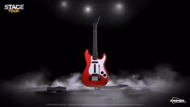 Guitare rouge Kramer dans le jeu Stage Tour sous des projecteurs avec fond de scène