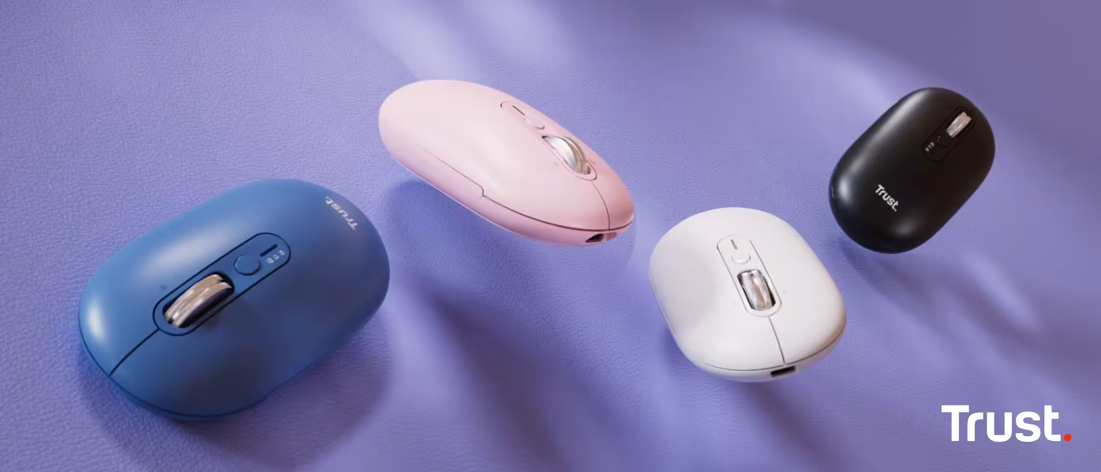 Quatre souris Trust Seron Slim en différentes couleurs sur fond violet