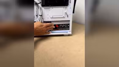 Photo main installant alimentation Apex dans un boîtier fond neutre