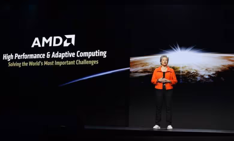 Advancing AI 2026 : AMD cale son événement IA les 22–23 juillet à San Francisco 1 Présentation AMD sur scène avec sujet et logo, éclairage professionnel, fond sombre