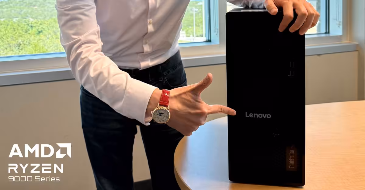 Personne pointant du doigt boîtier Lenovo ThinkStation, logo AMD Ryzen visible, éclairage naturel.