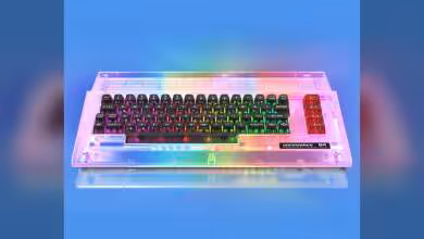 Clavier Commodore C64C transparent avec rétroéclairage LED arc-en-ciel sur fond bleu.