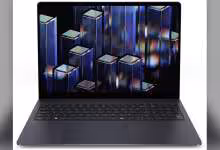PC portable Dell gris foncé, vue de face, clavier complet et écran affichant des motifs colorés