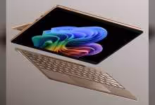 Microsoft Surface Laptop rose cuivré, écran Windows 11 affichant un fond d’écran coloré, clavier détachable.