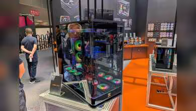 Boîtier XIGMATEK Lumina Core noir vitré avec éclairage RGB, exposé sur un stand de salon
