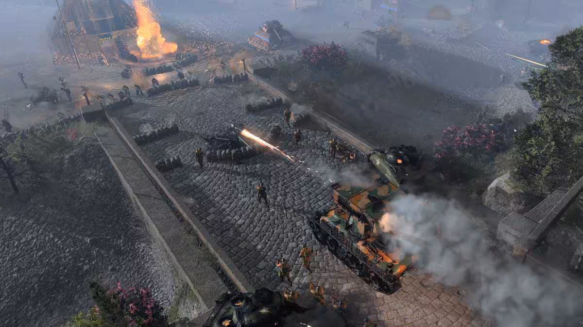 Company of Heroes 3 Final Stand sort en standalone avec coop, roguelite et 12 vagues 3 Combat de chars et d’infanterie dans Company of Heroes 3, vue aérienne sur un village détruit
