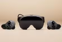 Casque VR Steam Frame noir avec deux contrôleurs SteamVR sur fond beige