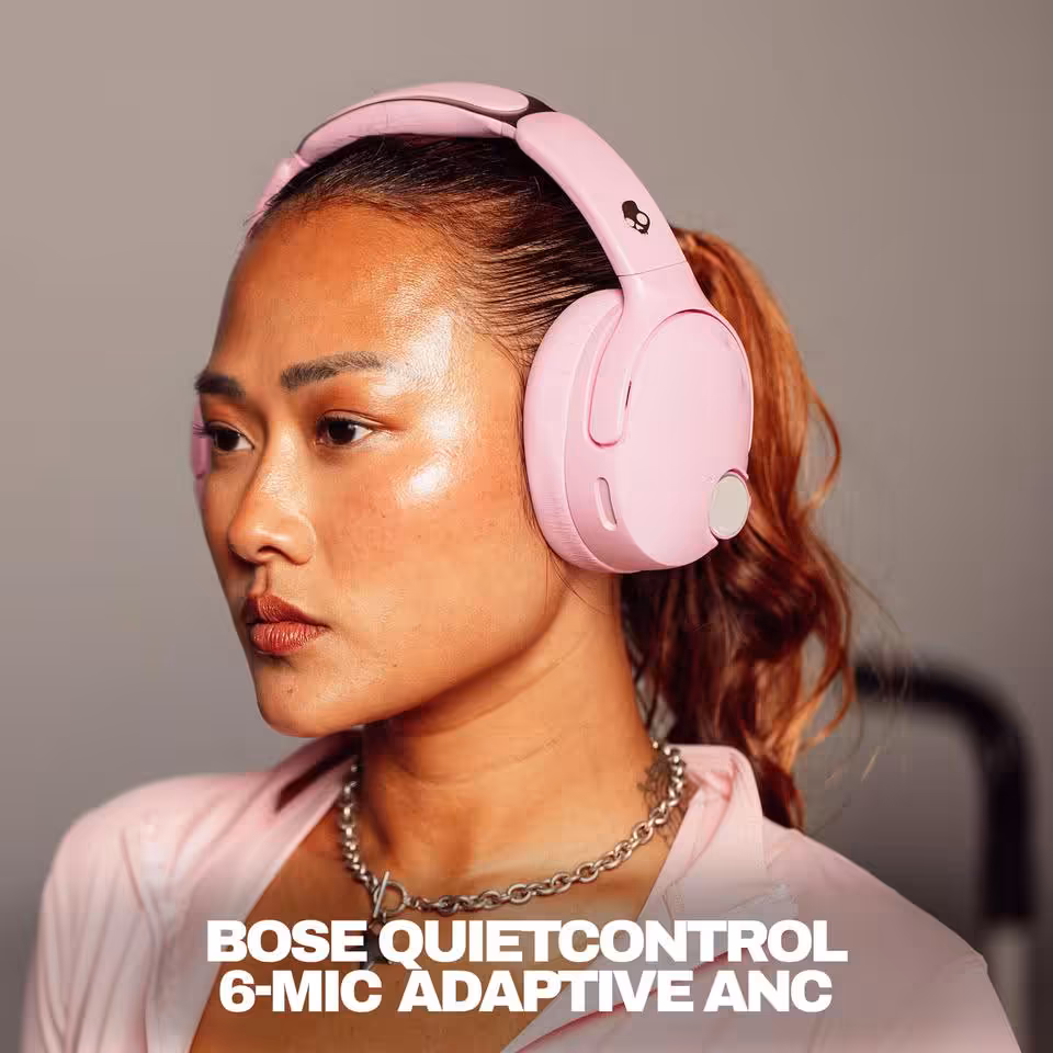 Skullcandy Crusher 1080 ANC : le casque à basses sensorielles s'allie aux technologies Bose 6 Femme portant un casque Skullcandy rose avec texte “Bose QuietControl 6-Mic Adaptive ANC”.