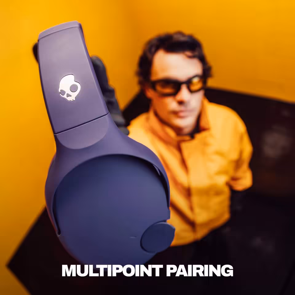 Skullcandy Crusher 720 : THX Spatial Audio, 65 h d’autonomie et basses réglables 5 Casque Skullcandy violet avec logo crâne, effet multipoint pairing, homme en arrière-plan