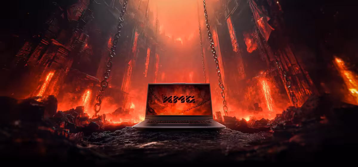 Ordinateur portable XMG APEX 17 posé dans un décor volcanique rouge, écran avec logo XMG visible