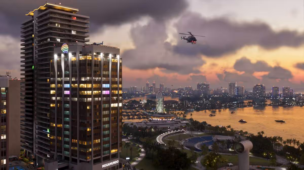 GTA 6 durerait autour de 80 heures, bien au-delà de GTA 5 et Red Dead Redemption 2 2 Grand immeuble côtier de Vice City au coucher du soleil, hélicoptère au-dessus de la baie