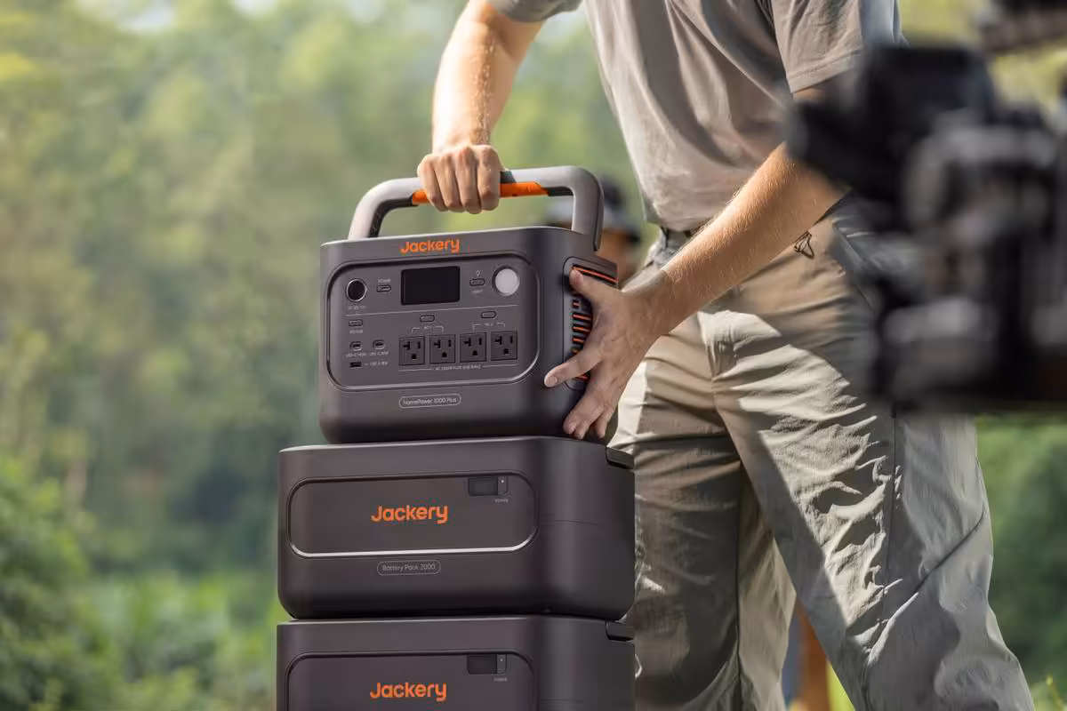 Jackery HomePower 1000 Plus V2 : une station 1 024 Wh extensible à 11 kWh 7 Homme portant une station Jackery HomePower 1000 Plus V2 noire et modules empilés en extérieur