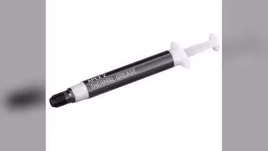 Cartouche Alphacool Apex 2 Thermal Grease, seringue noire et blanche sur fond blanc.