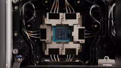 Gros plan d’une puce GPU au centre d’un système de refroidissement, avec câbles et ventilateurs visibles