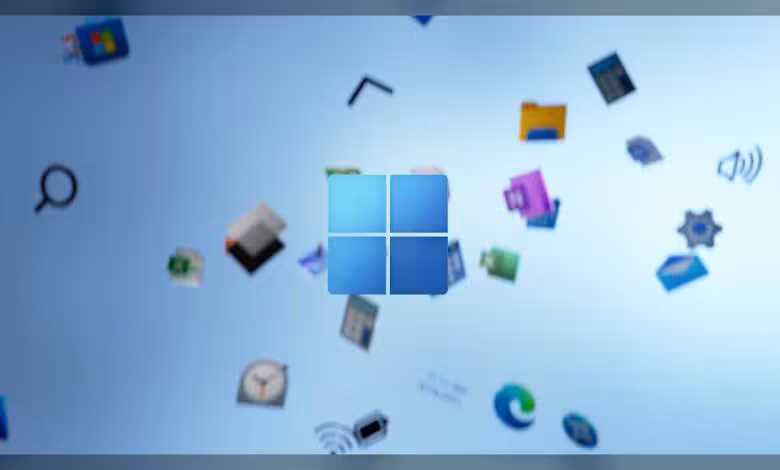Windows 11 : Microsoft efface discrètement la recommandation de 32 Go de RAM 1 Logo Windows 11 bleu au centre, avec icônes d’applications flottantes sur fond clair abstrait