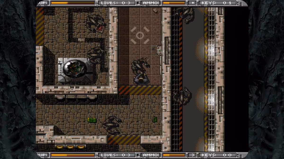 Capture de gameplay Alien Breed en vue aérienne dans un complexe spatial industriel
