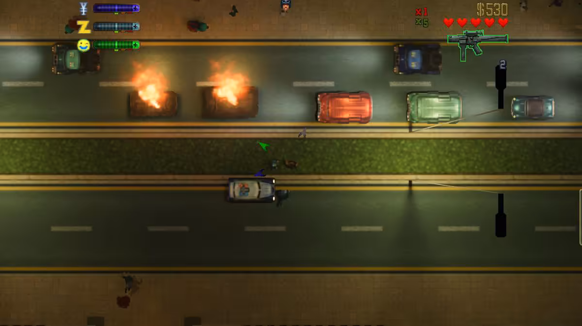 Vue aérienne nocturne de GTA 2 RTX Remix, véhicules et explosions sur une avenue urbaine