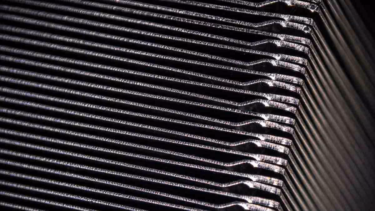 Gros plan sur les ailettes métalliques d’un dissipateur thermique JouleForce de Noctua