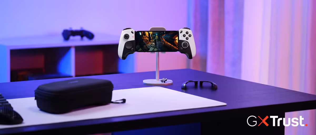 Manette mobile Trust GXTrust noire avec smartphone en jeu sur support, lumière néon violette