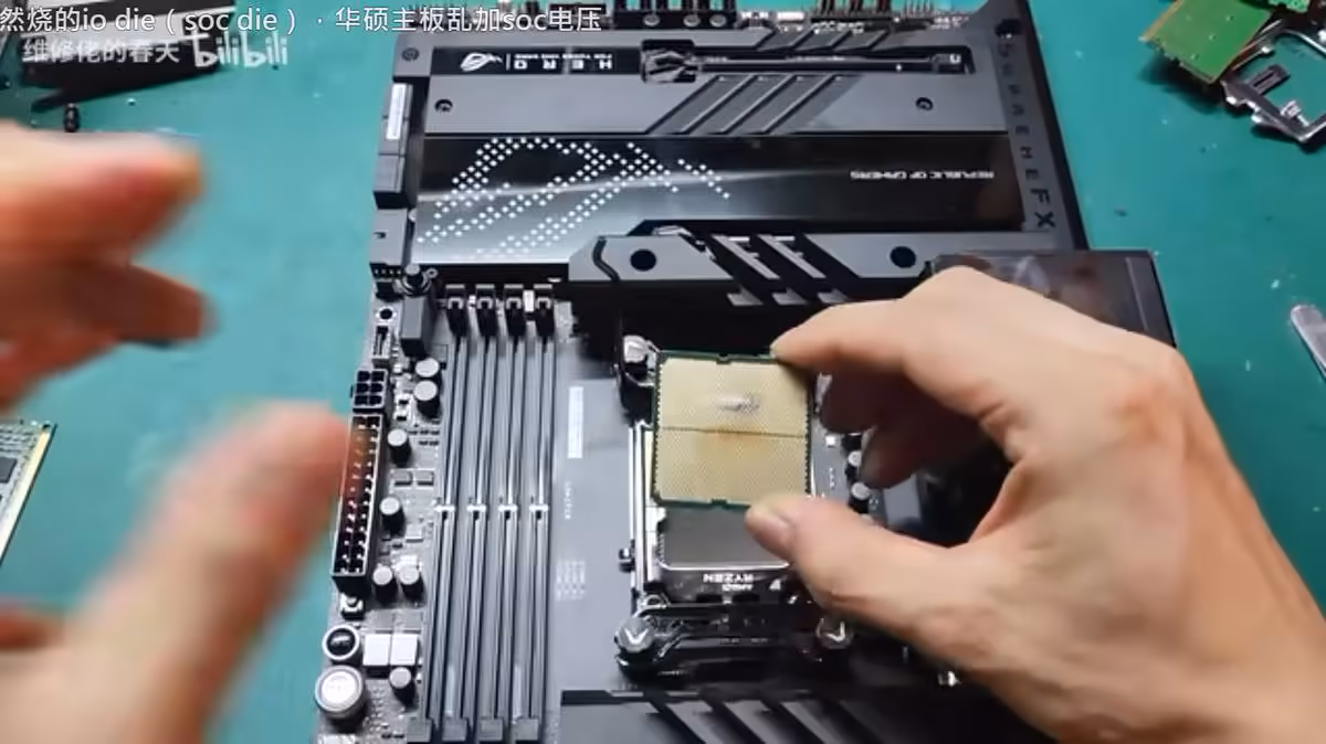 Ryzen 7 7800X3D processor held above an AM5 motherboard during inspection