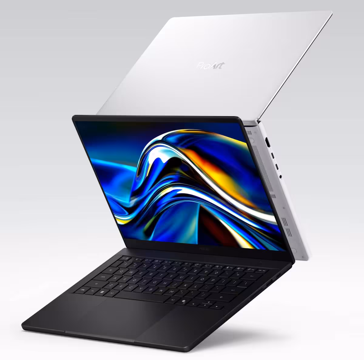 Ordinateurs portables ASUS ProArt P16 noir et ProArt P14 blanc ouverts, affichant un visuel abstrait coloré