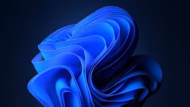 Fond d’écran abstrait bleu emblématique de Windows 11 sur arrière-plan sombre## +#+#+#+#+#+